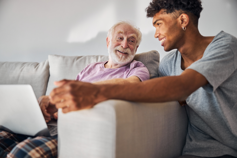 Cheerful elder man and a volunteer spending time together